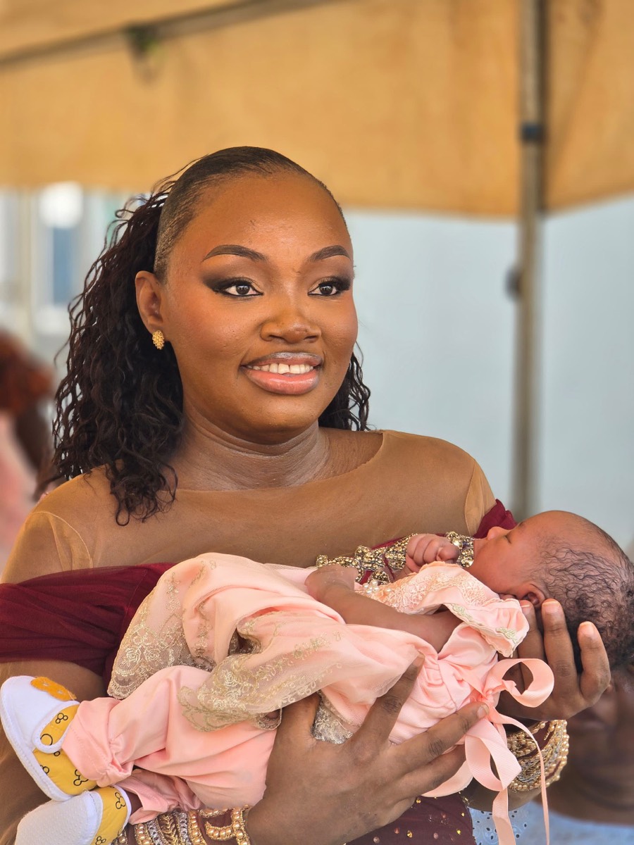 Chidimma holding baby Oyin with tenderness